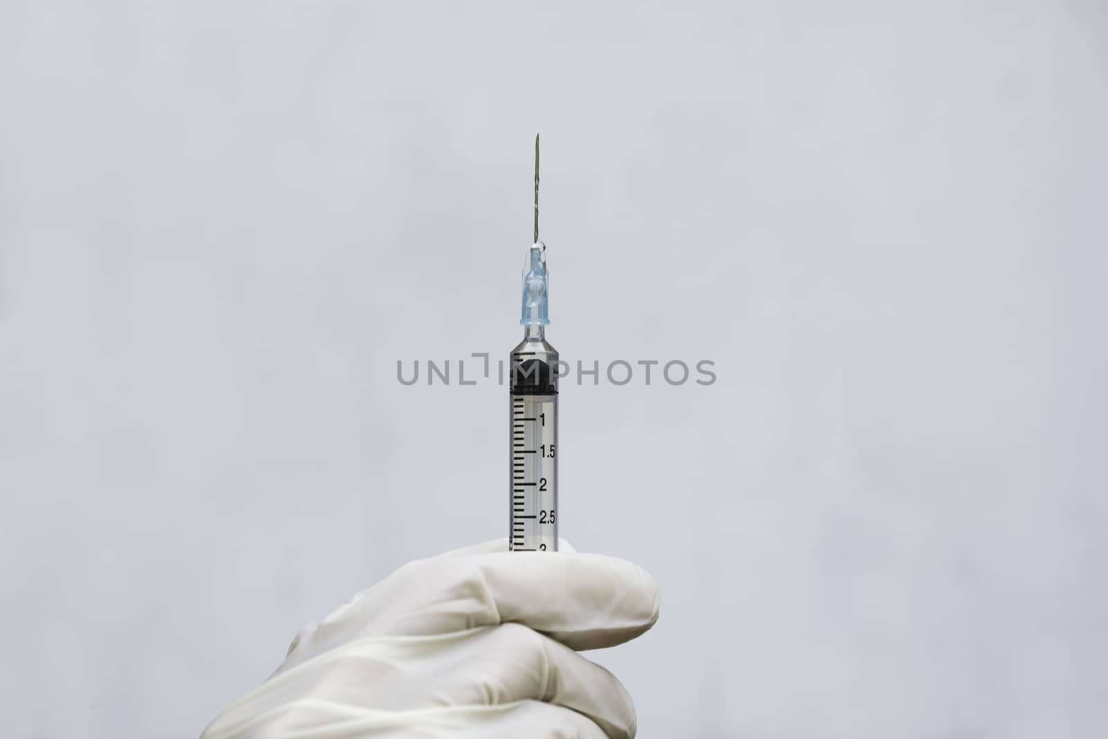 Hand of doctor holding syringe and drug, medical concept. by kirisa99