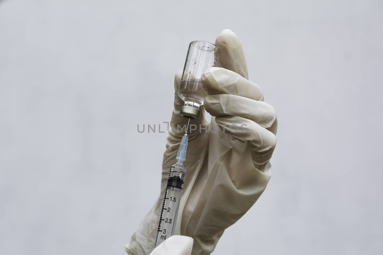 Hand of doctor holding syringe and drug, medical concept.