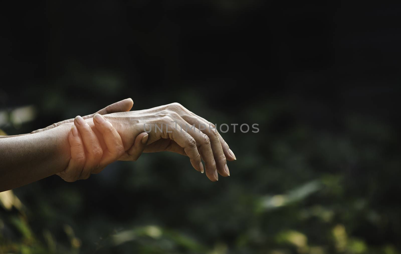 Female holding wrist. Pain in a woman wrist. Woman massaging pai by kirisa99