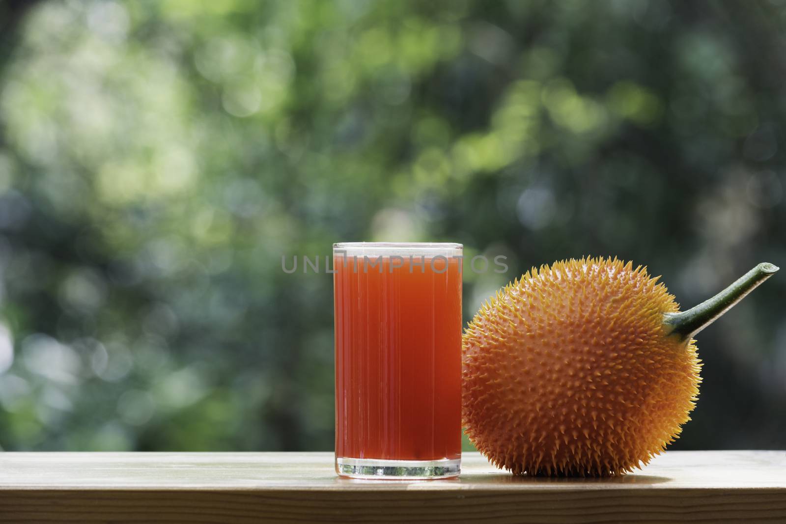 Baby Jackfruit, Gac fruit with baby jackfruit juice on blurred background. Drink and healthy concept.