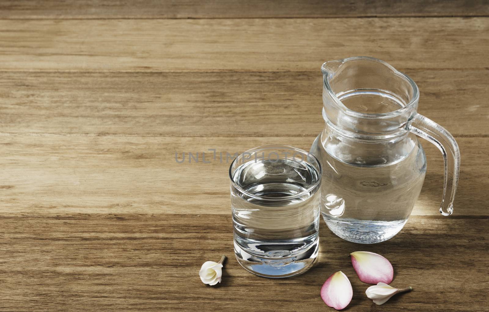 Water glass with glass jar on wooden table. Glass and clean drin by kirisa99
