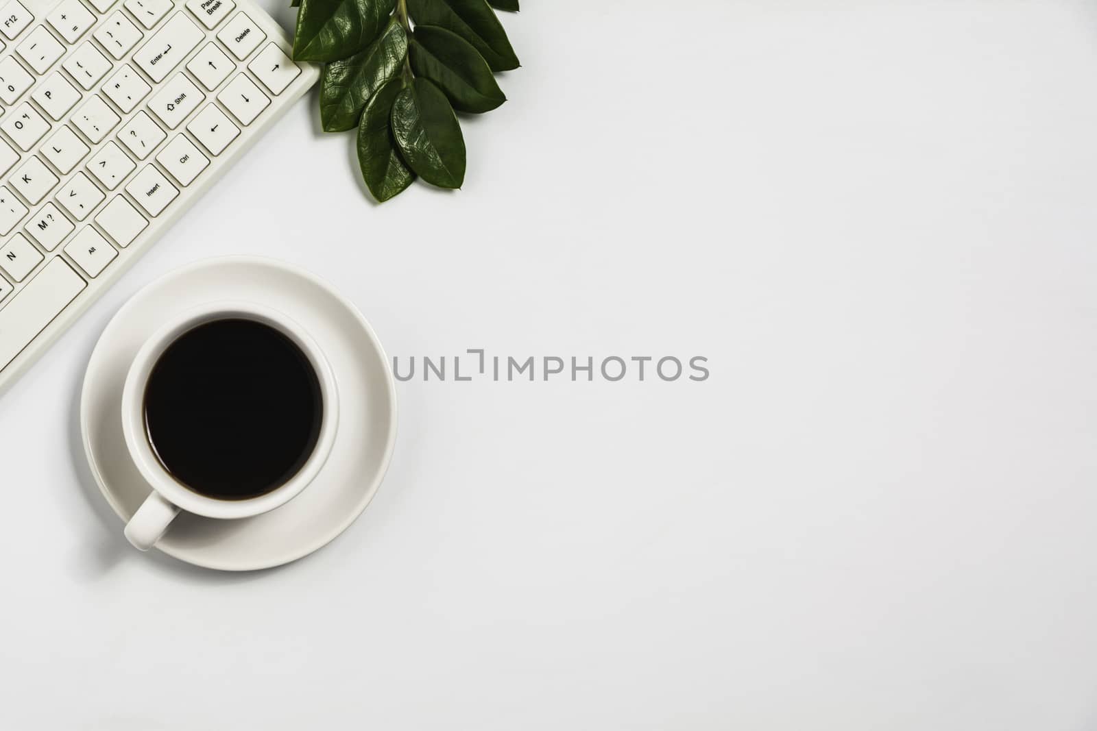 A coffee cup on white office desk with copy space. Business and workspace concept.