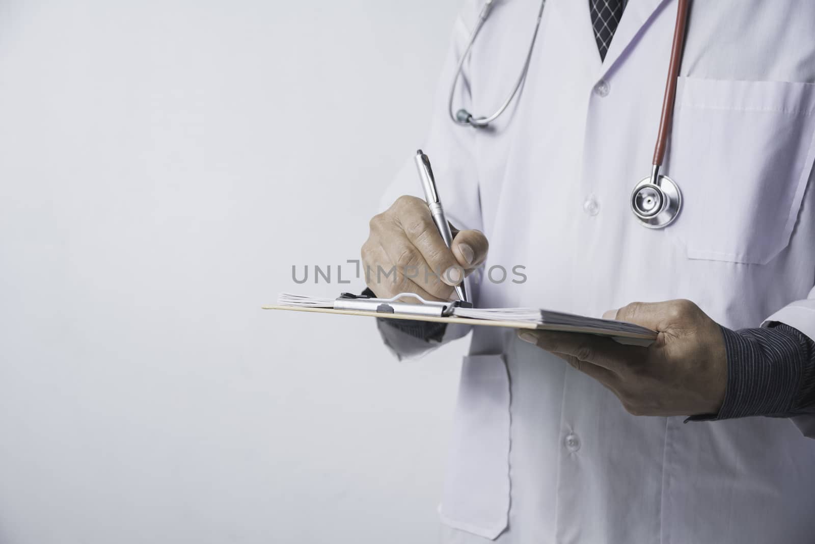 Medicine doctor with stethoscope and holding application form on white background. Healthcare and medicine.