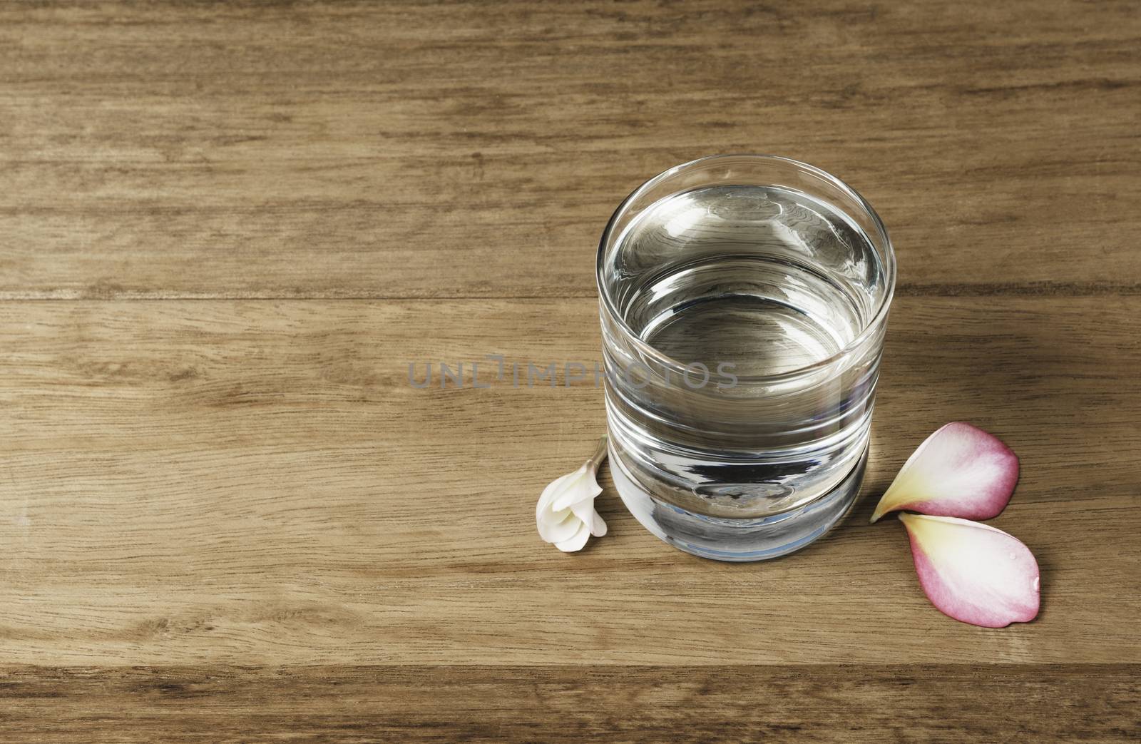 Water glass on wooden table. Glass and clean drinking water with copy space.