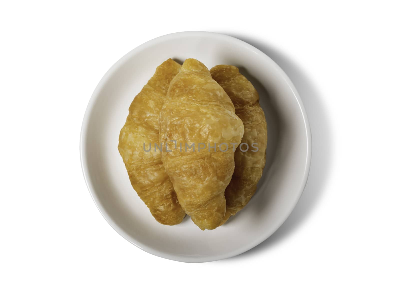 Fresh croissant on plate with clipping path isolated on a white background.