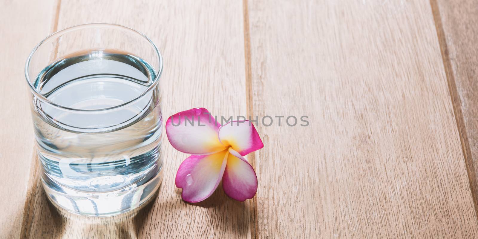 Water glass on wooden table. Glass and clean drinking water with by kirisa99