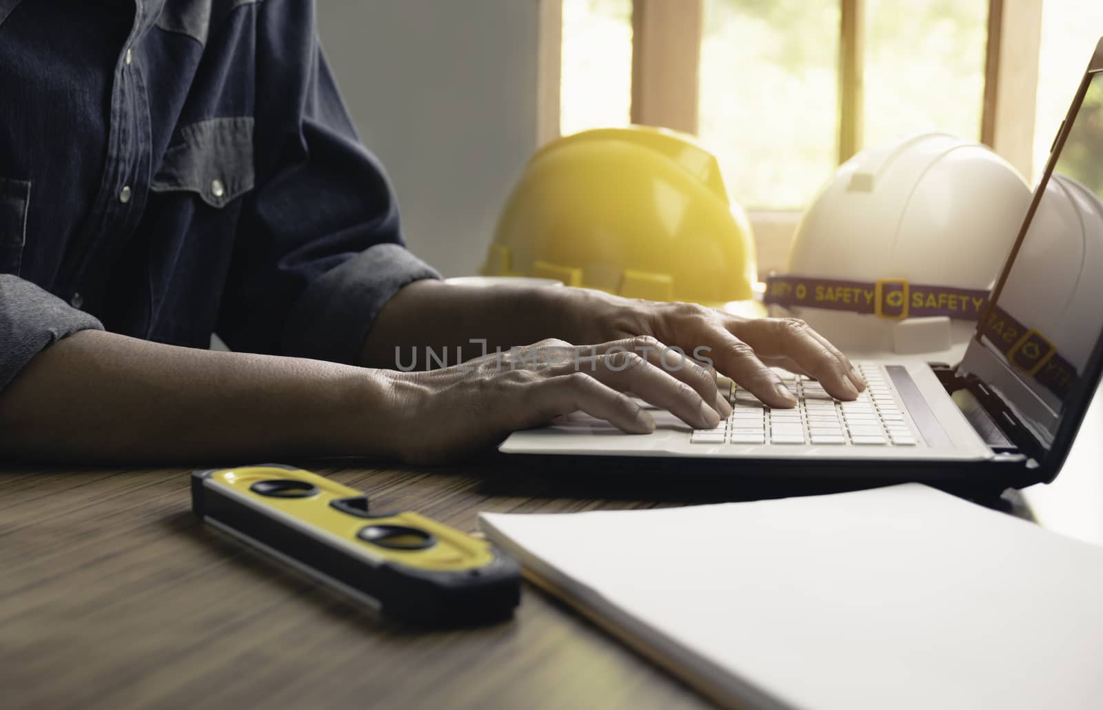 Architect engineer working concept and construction tools or safety equipment on table.