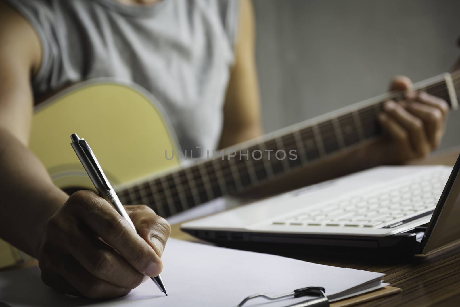 Composer holding pencil and writing lyrics in paper. Musician pl by kirisa99