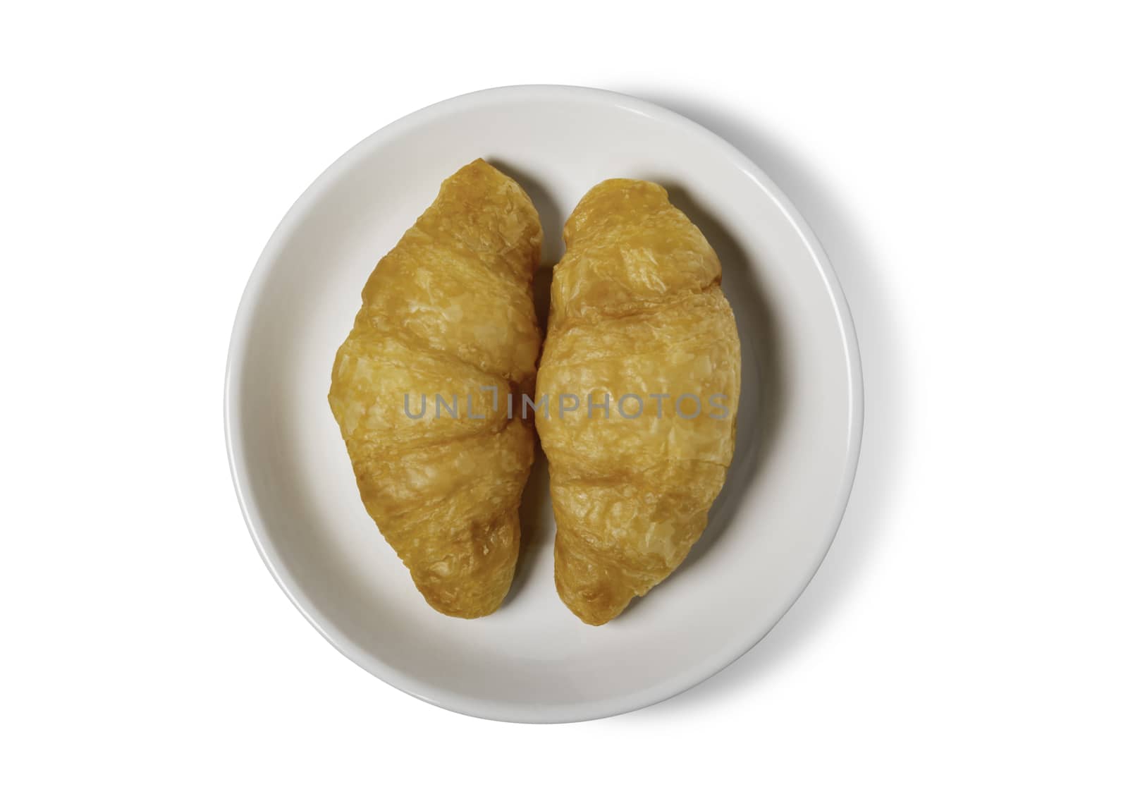 Fresh croissant on plate with clipping path isolated on a white background.