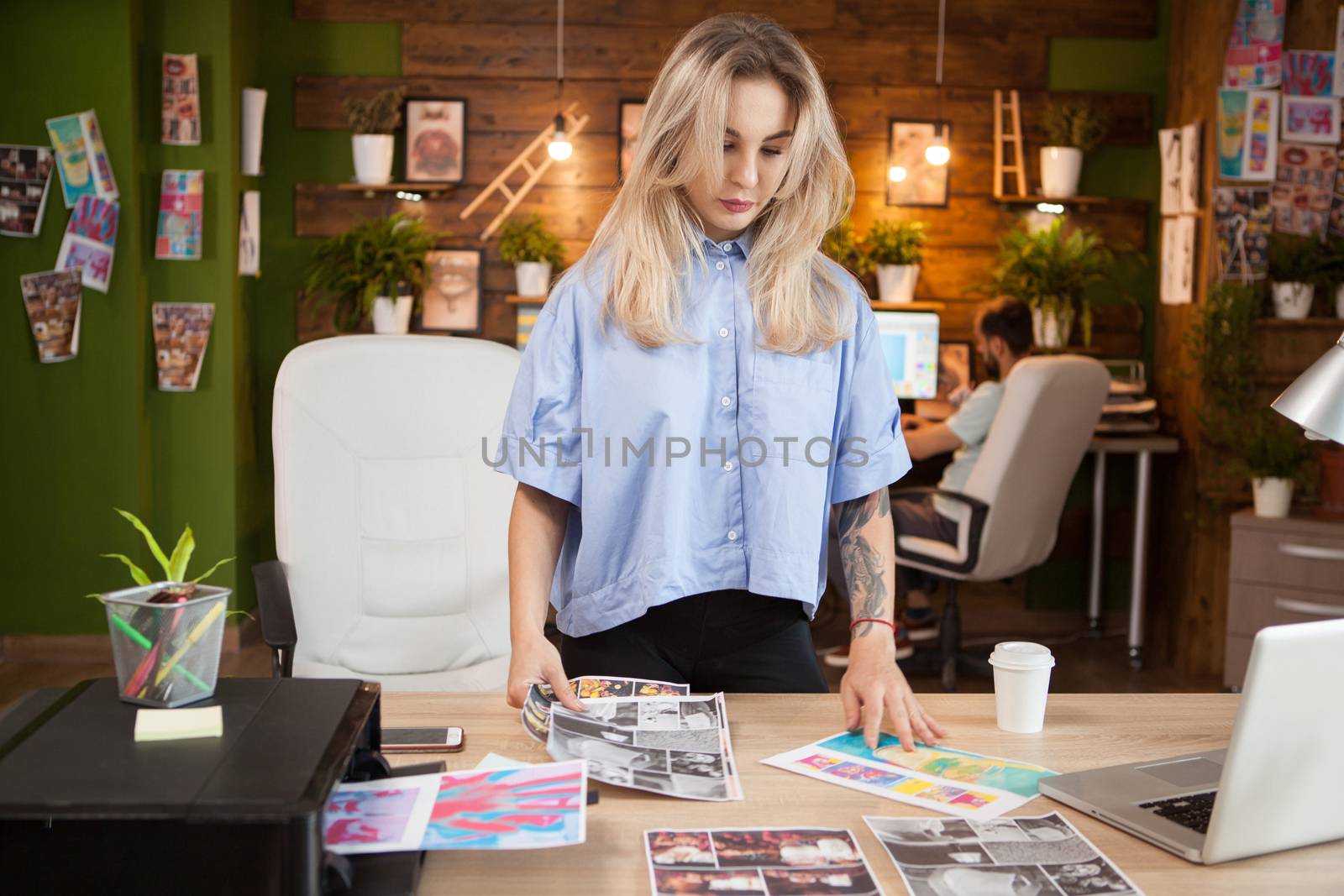 Businesswoman in creative office looking at drawings. Female designer.