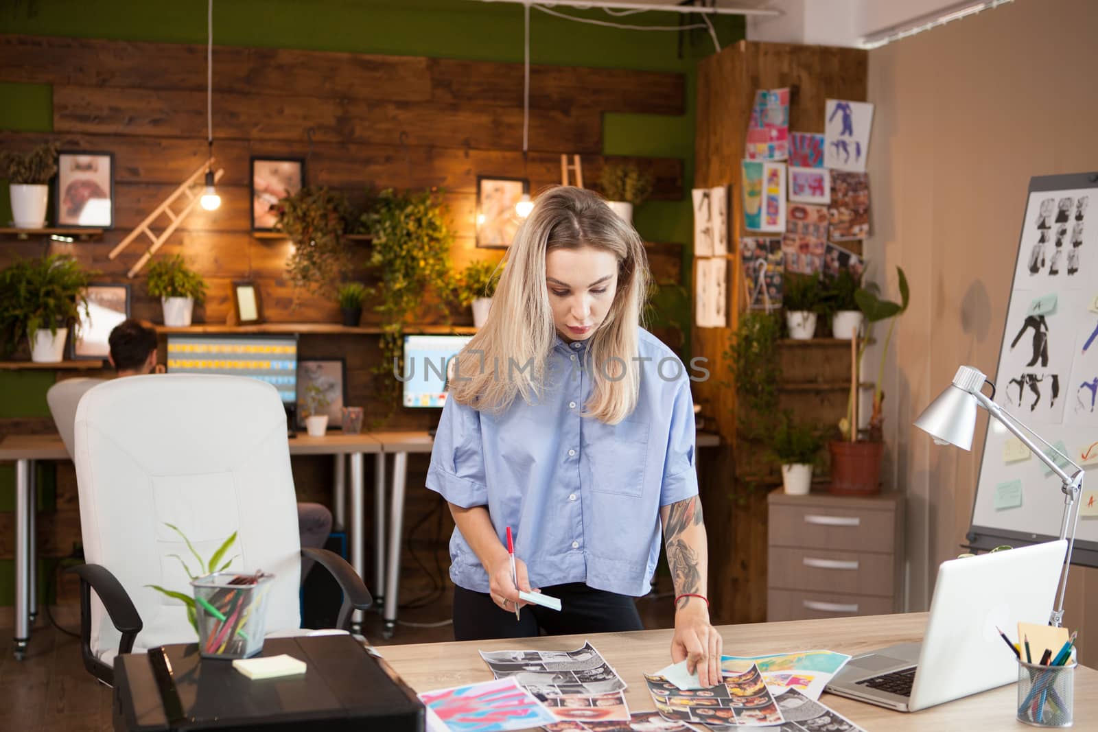 A young fashion designer in creative office by DCStudio