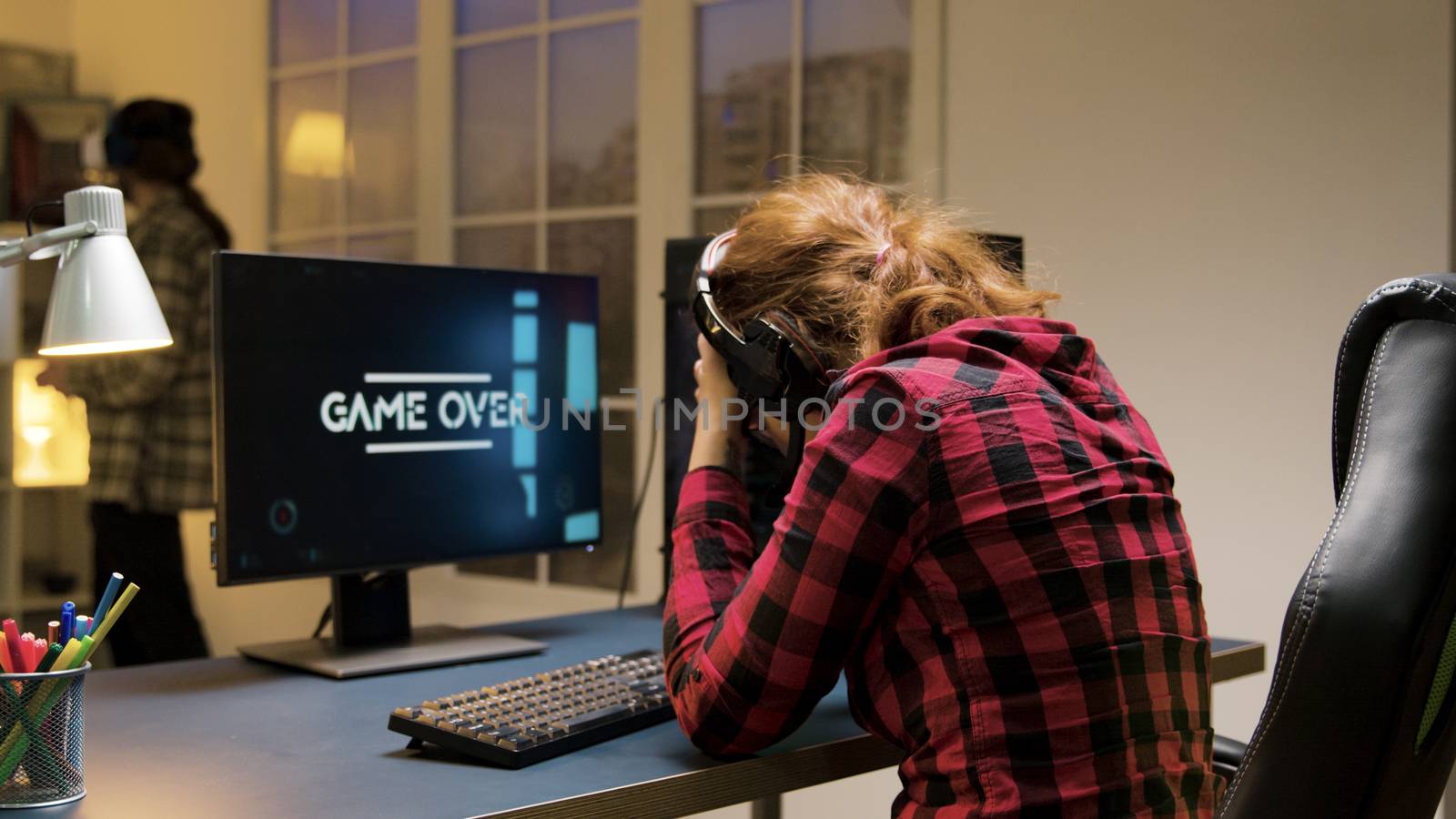 Game over for a professional caucasian female gamer by DCStudio