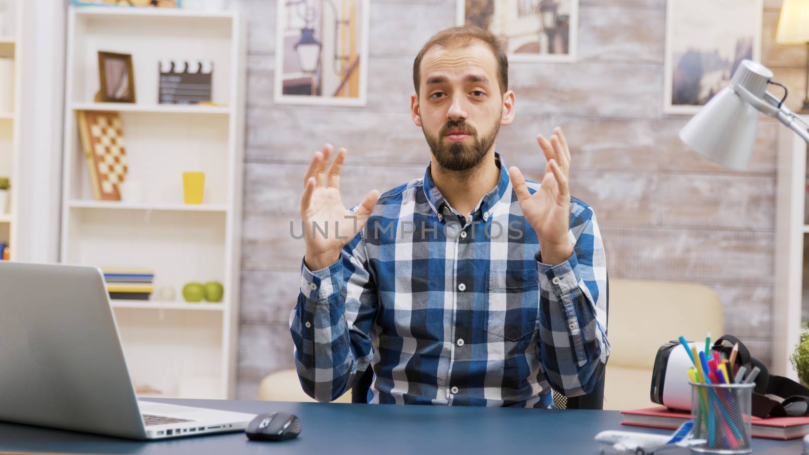 Bearded young influencer looking at the camera by DCStudio