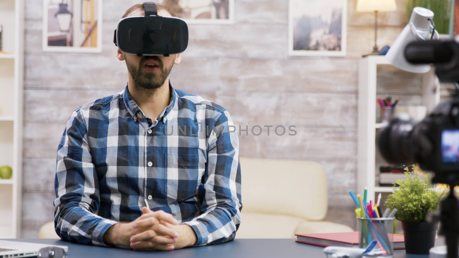 Famous influencer using virtual reality goggles while recording new episode. Creative content creator.