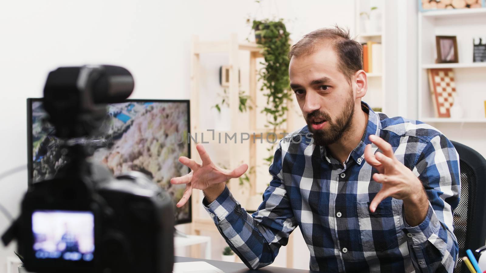 Young man recording a vlog for his social media channel by DCStudio