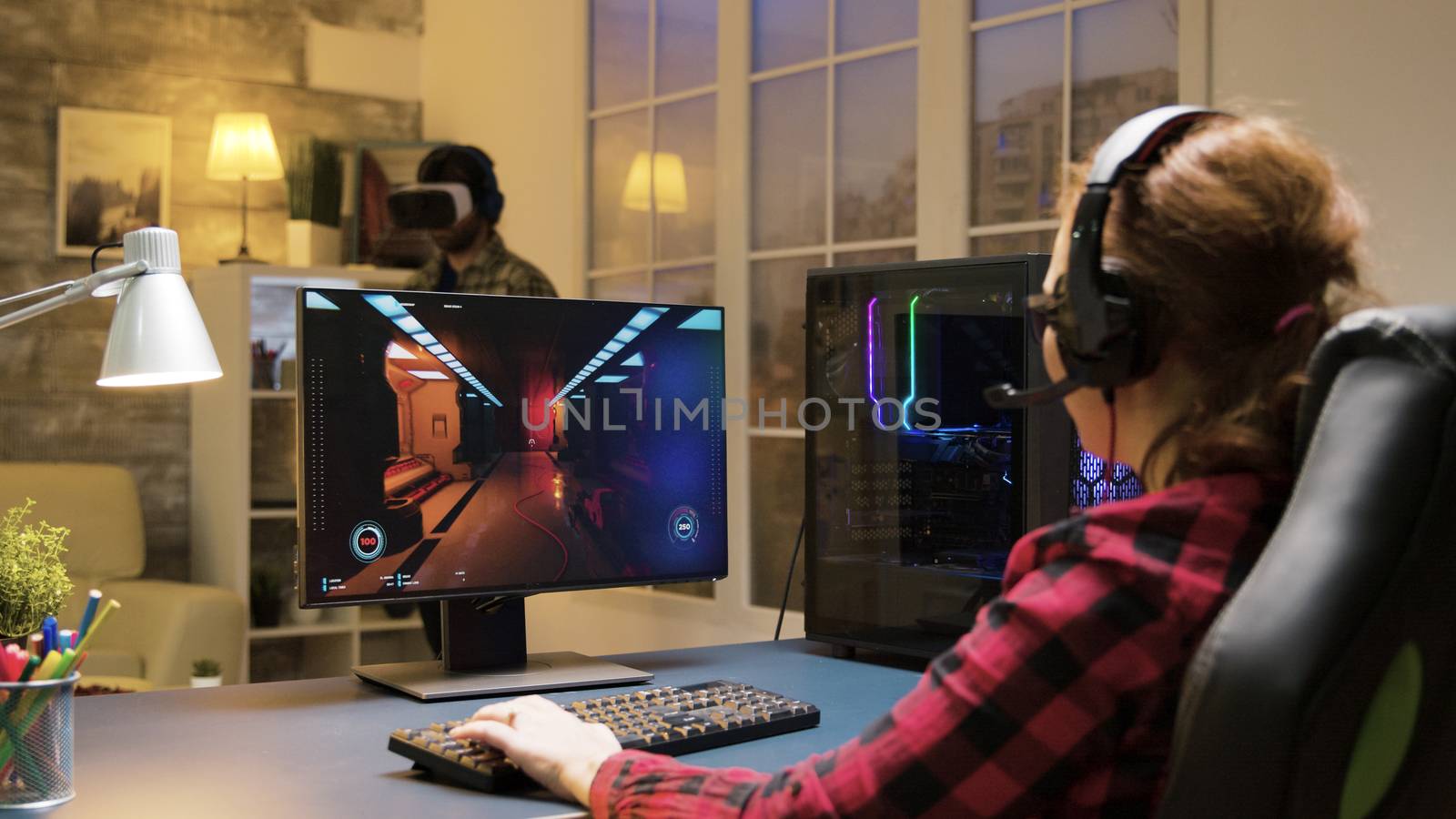 Woman with headphones relaxing playing computer games by DCStudio