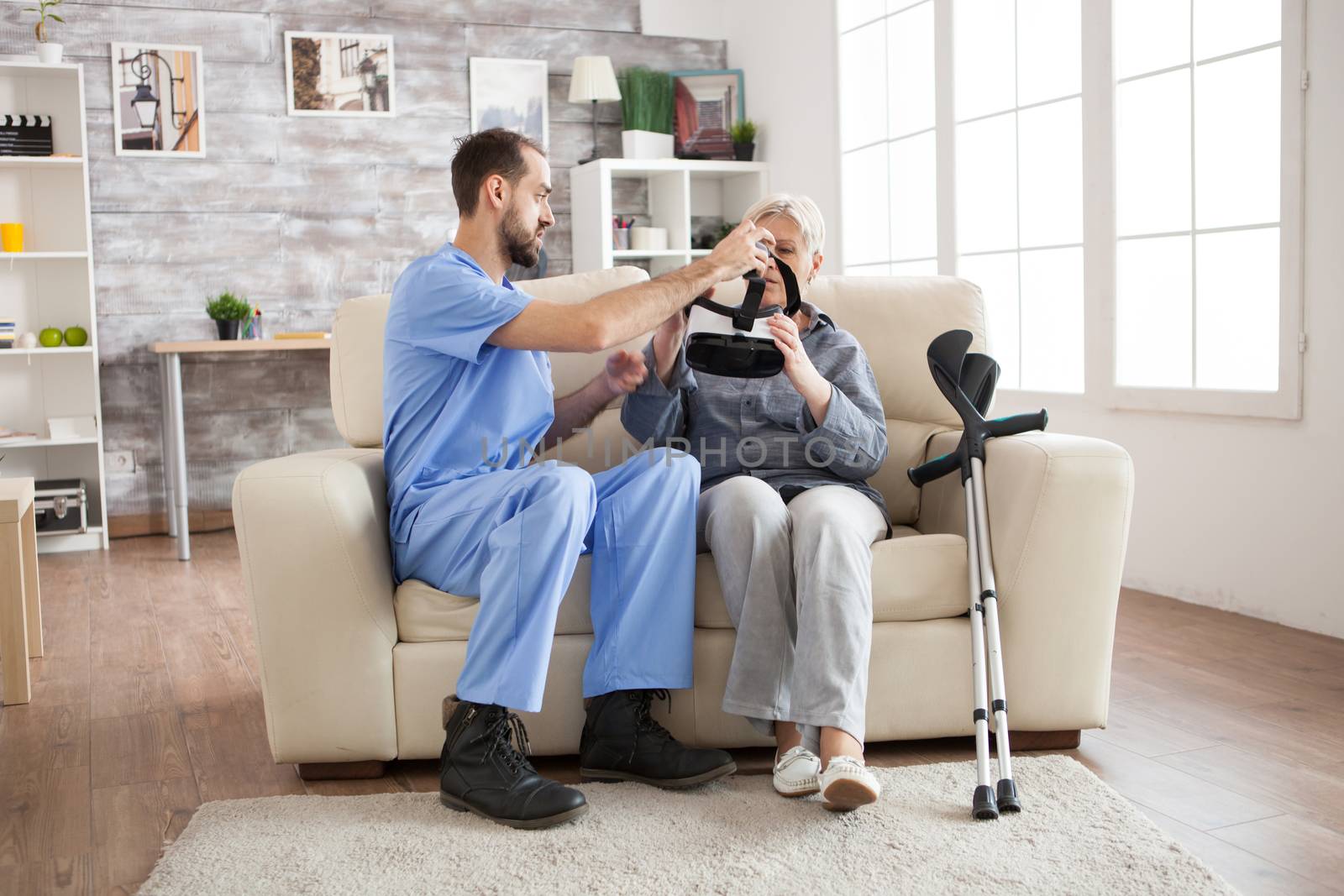 Caucasian doctor in nursing home with senior woman by DCStudio