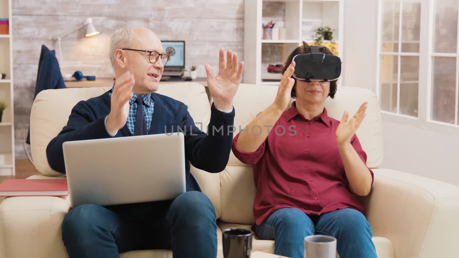 Amazed senior woman while using virtual reality goggles by DCStudio
