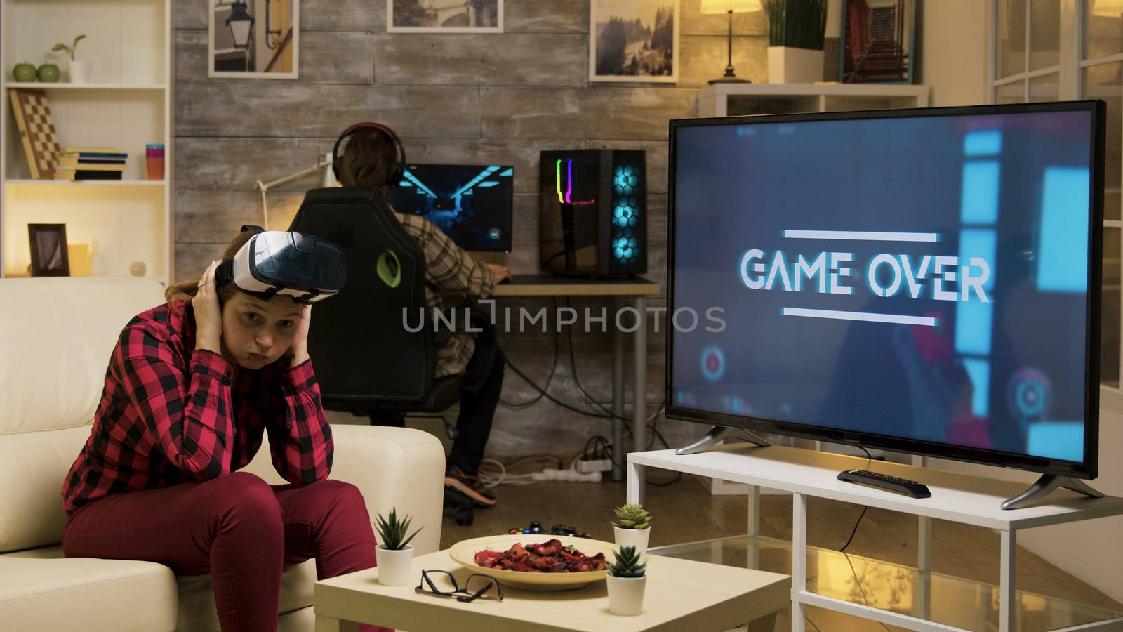 Woman experiencing virtual reality while playing video games using vr headset. Game over for female gamer.