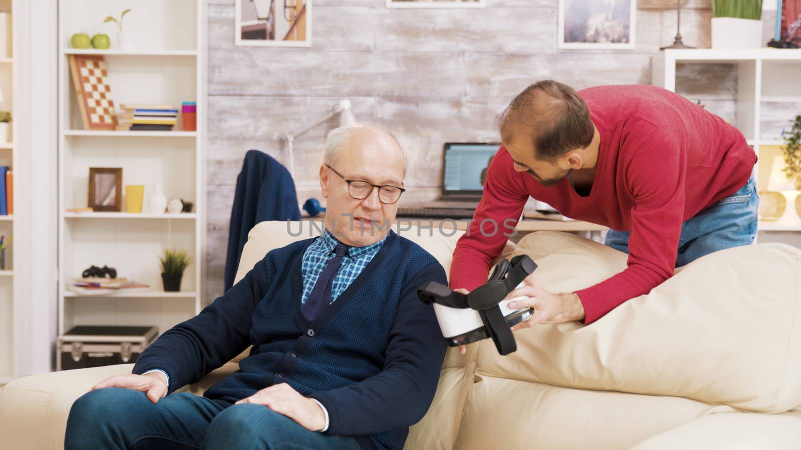 Nephew showing his grandfather how to use VR headset by DCStudio