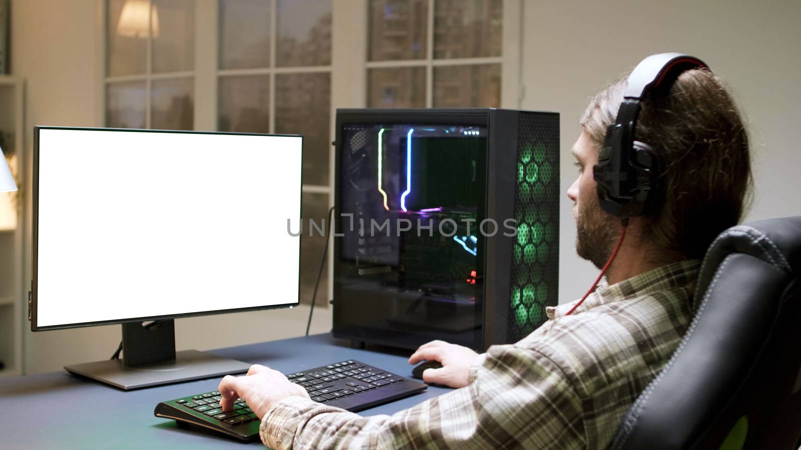 Man with headphones sitting on gaming chair by DCStudio