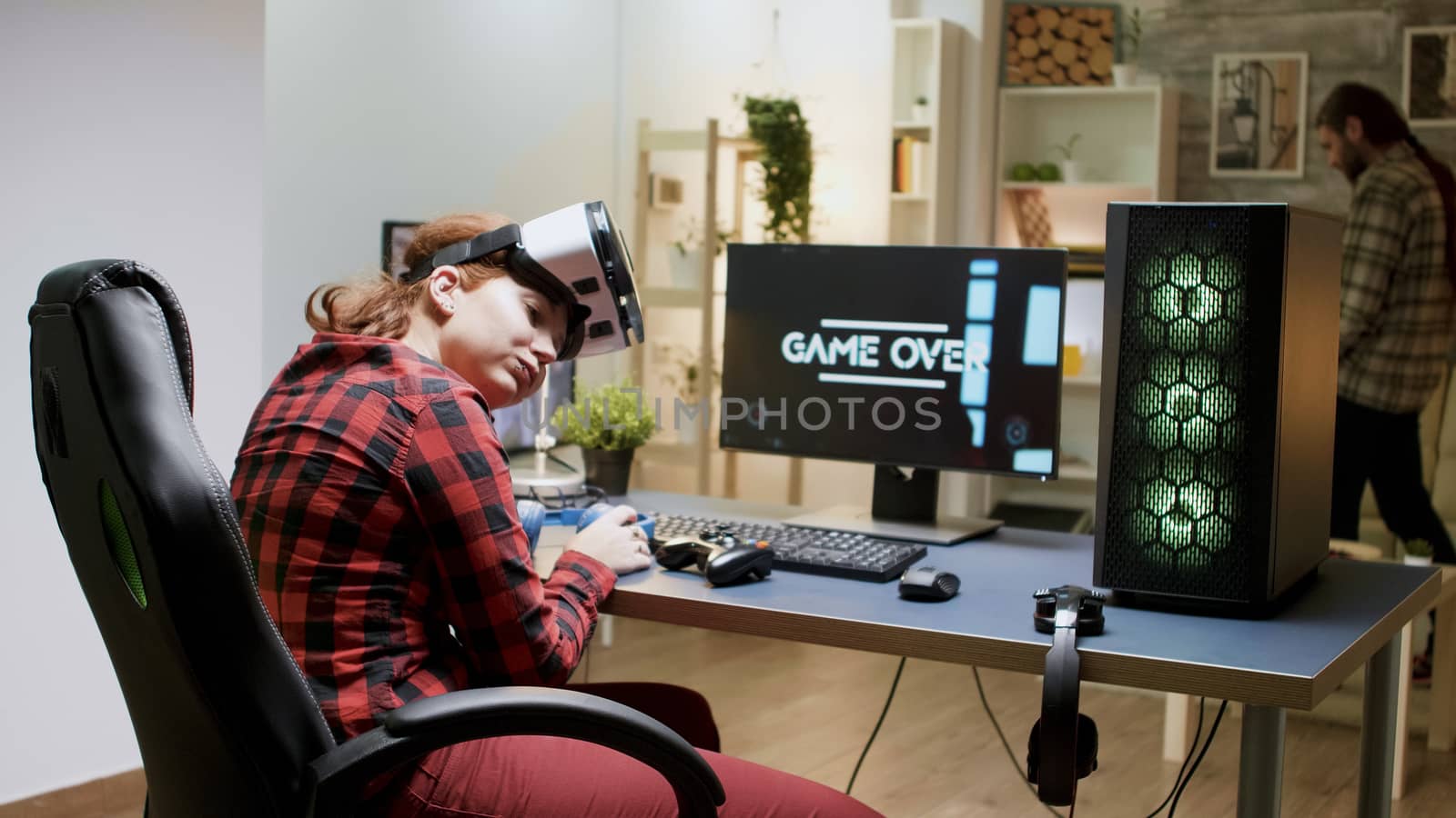 Gamer girl losing video game tournament while playing with VR headset late at night in her room