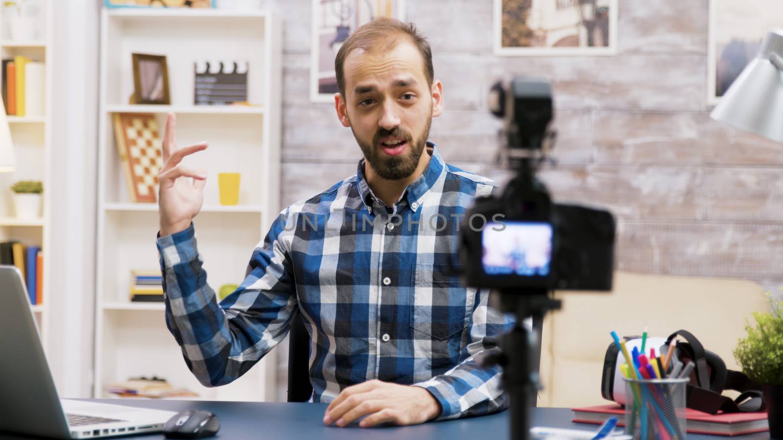 Excited influencer while recording for his vlog in living room. Famous creative man.