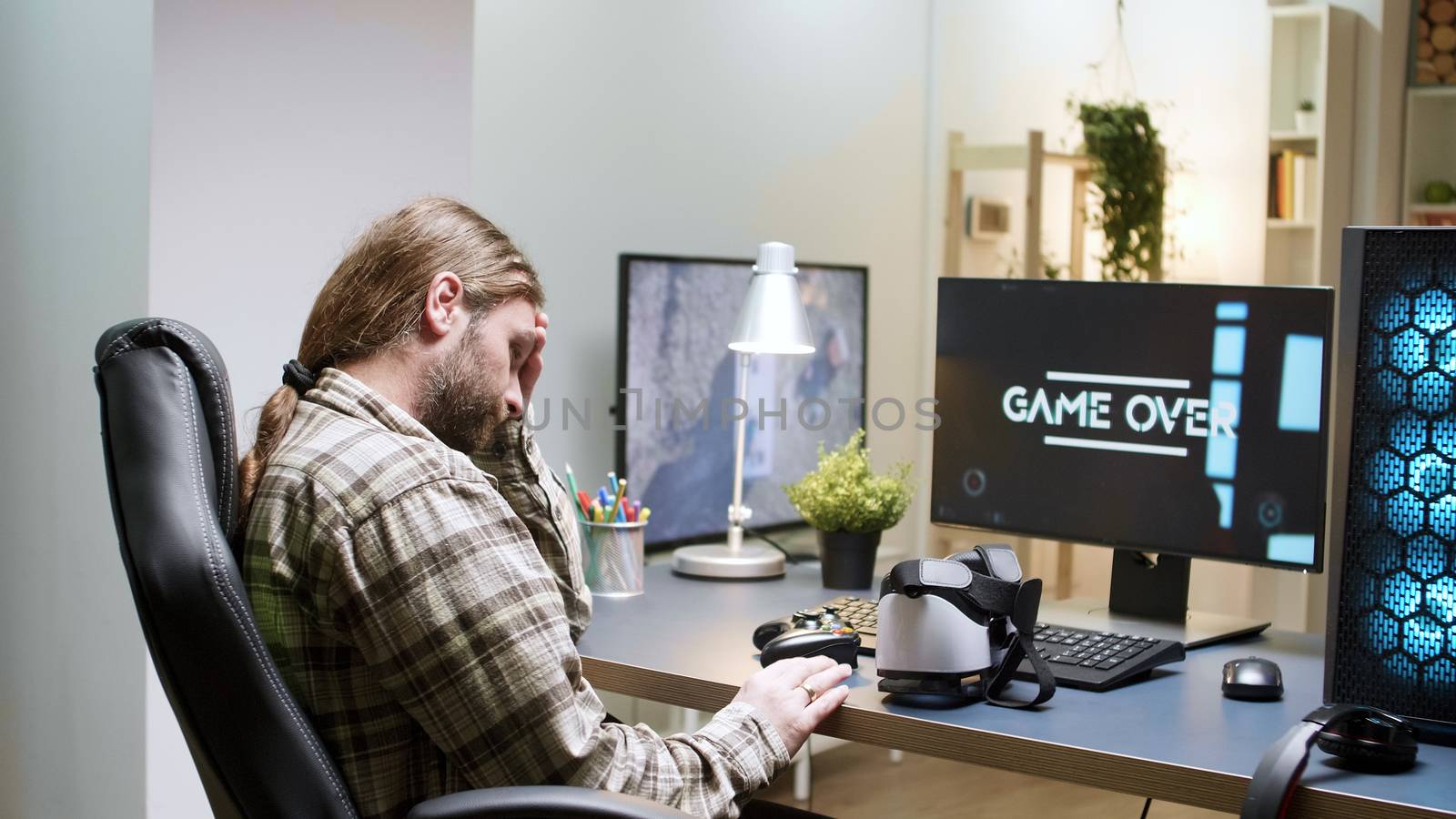 Game over for man sitting on gaming chair using vr headset. Modern technology for gaming.