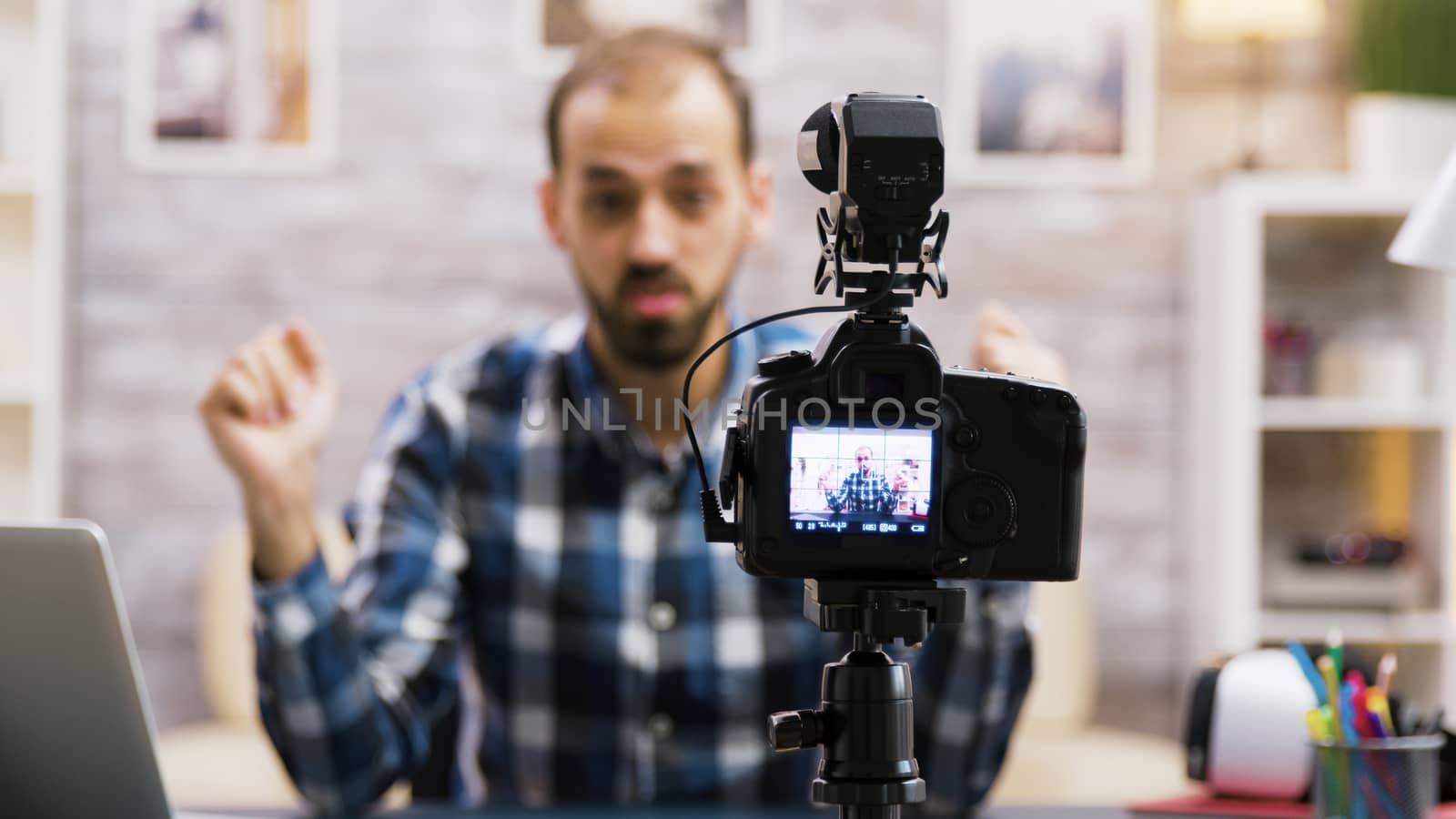 Creative young man talking in front of camera by DCStudio