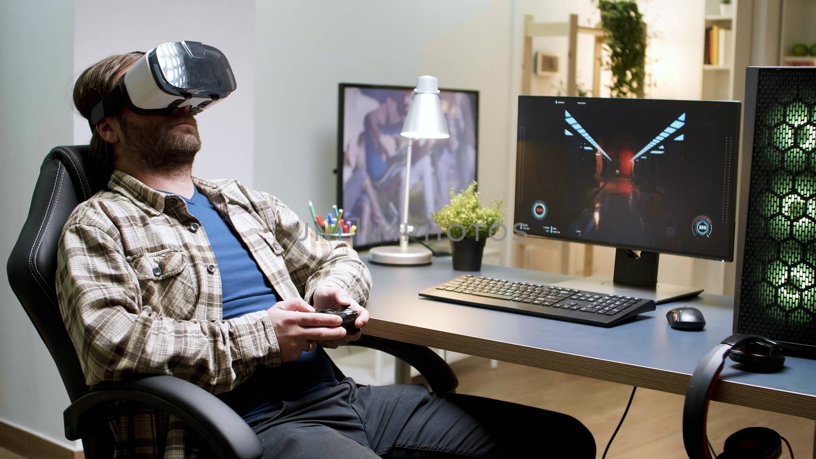 Bearded man sitting on gaming chair playing games by DCStudio