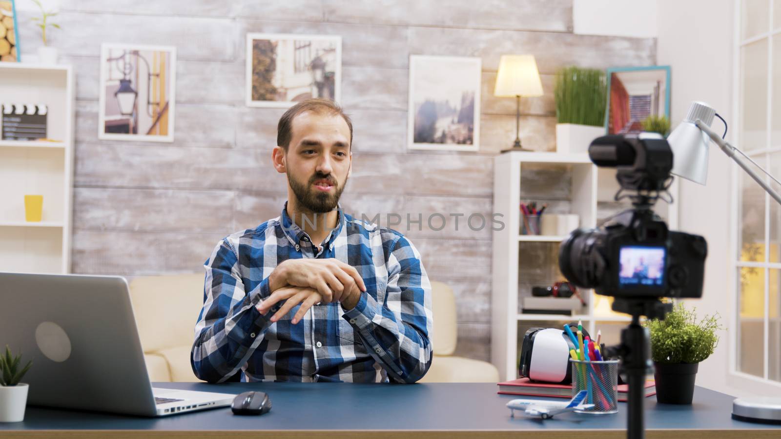 Caucasian vlogger recording a podcast for social media. Creative young influencer.