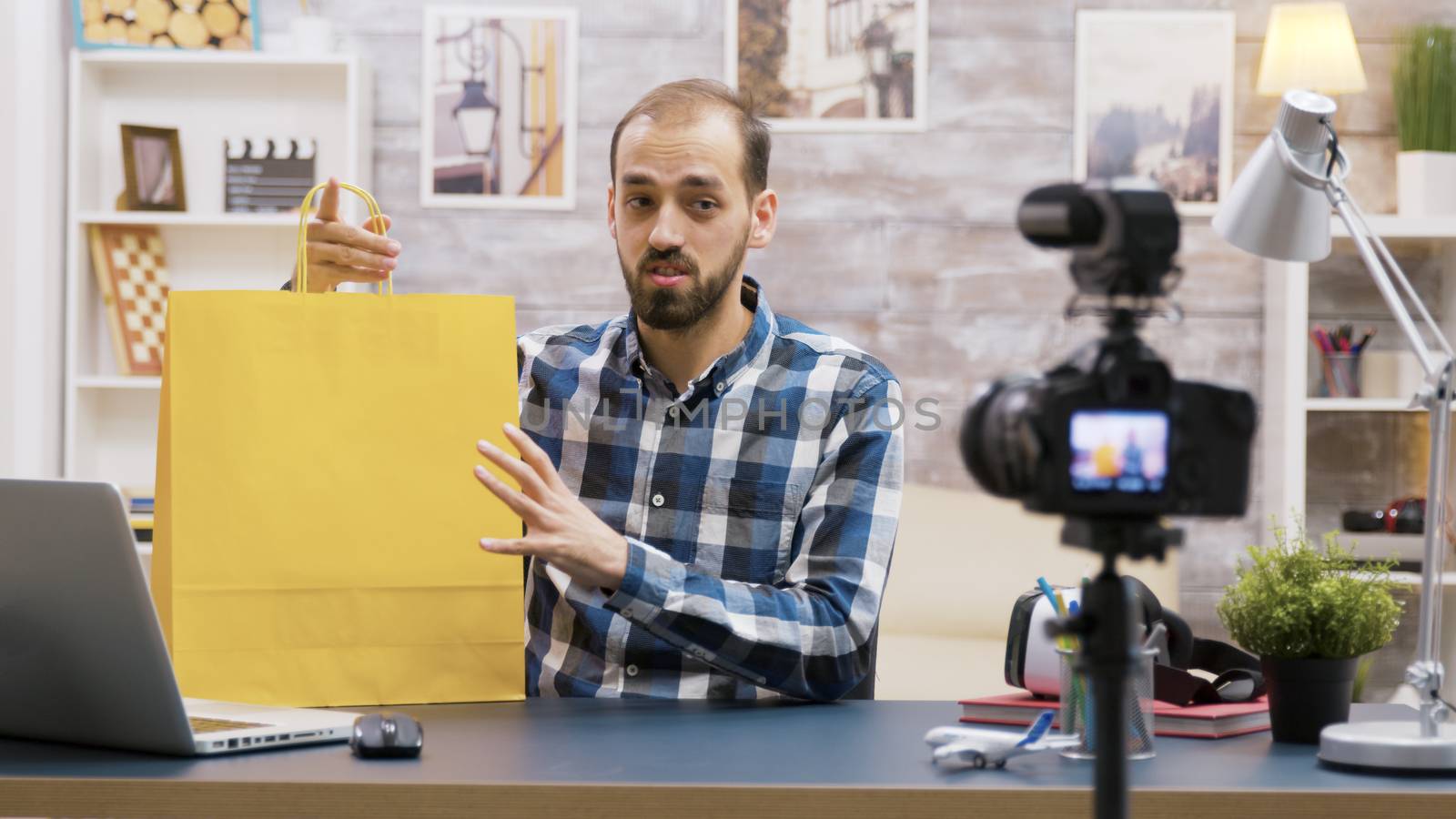 Young vlogger presenting a special giveaway for his followers. Famous influencer. Creative content creator.