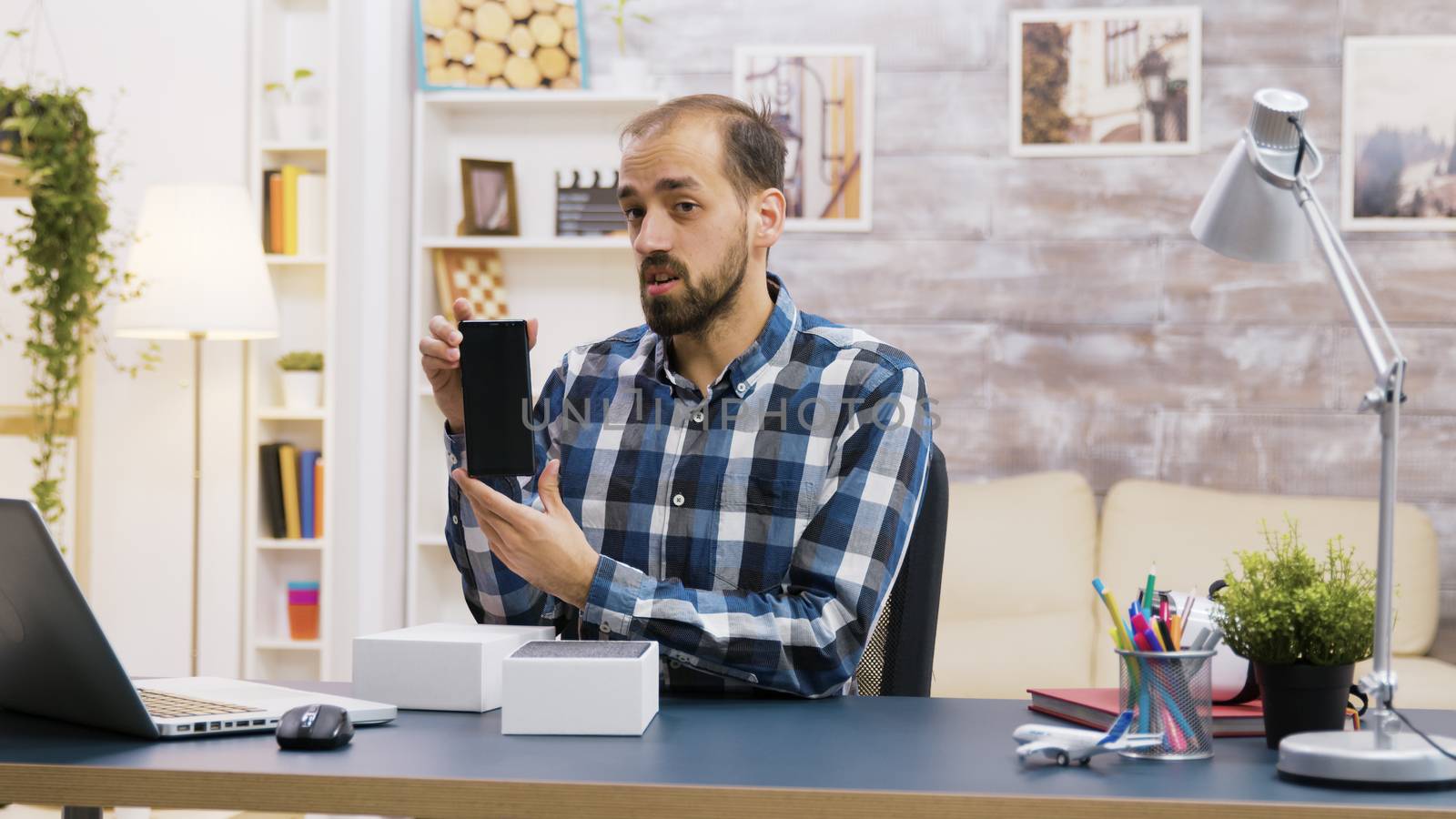 Famous influencer recording the unboxing of modern phone. Creative content creator.