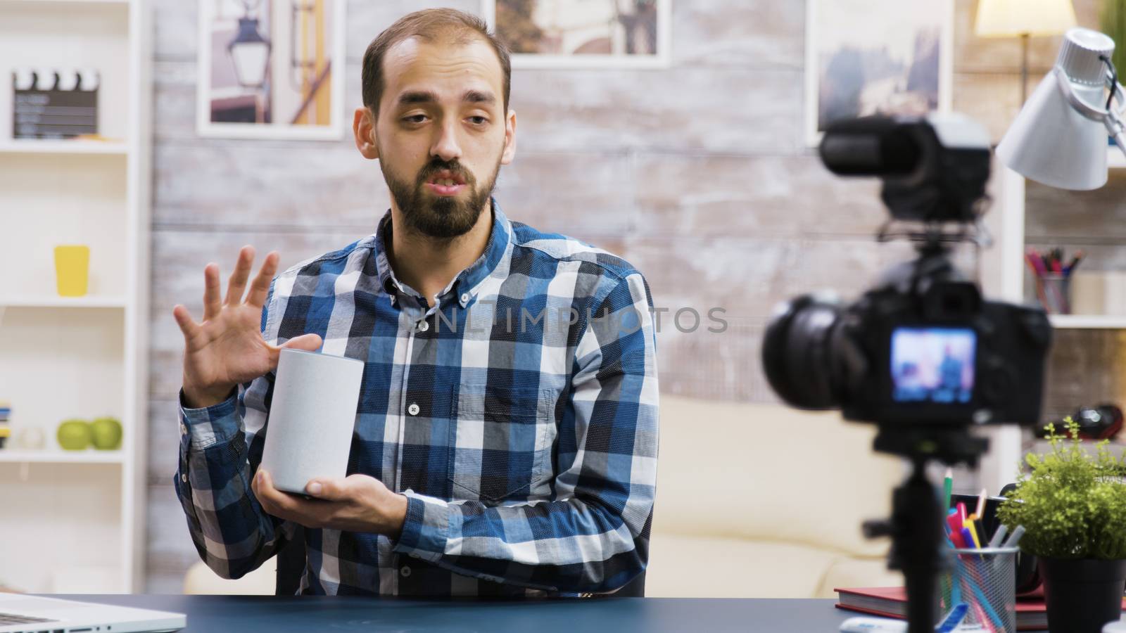 Famous vlogger filming smart speaker review for his followers. Influencer recording new vlog.