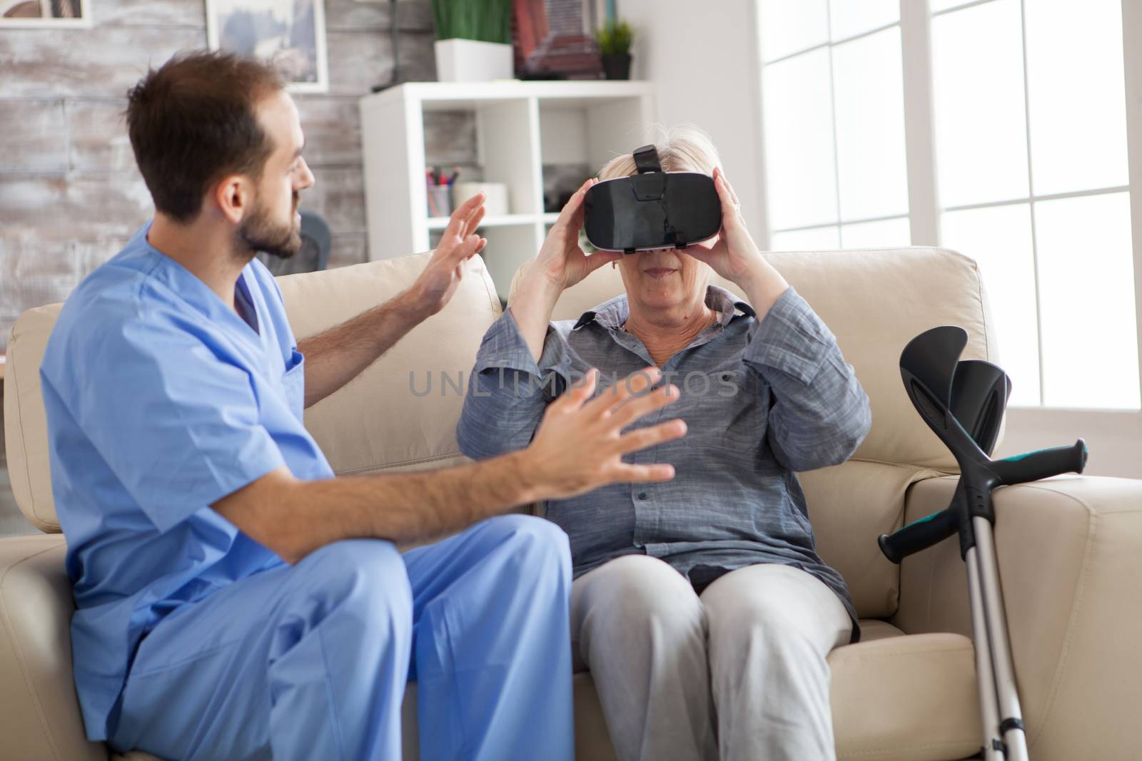Older patient using virtual reality glasses in nursing home to see her spine.