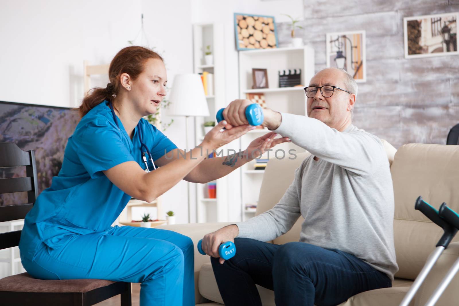 Senior man in nursing home with doing physical therapy by DCStudio