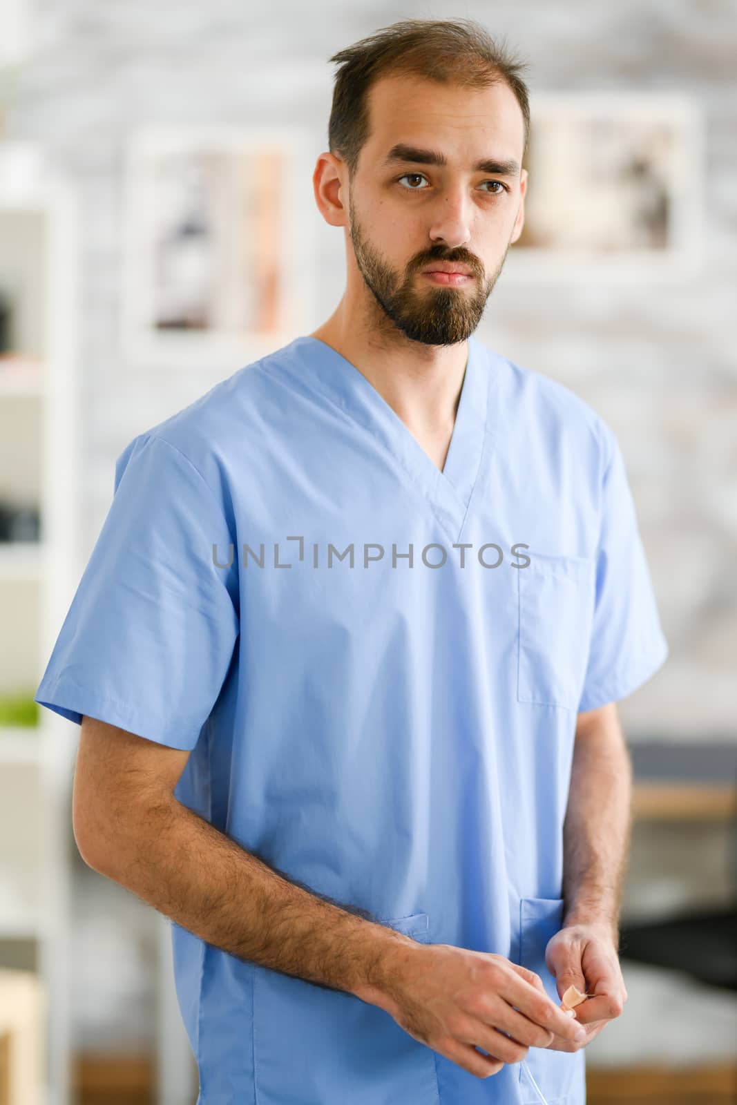 Portrait of young doctor in his uniform. Nursing home.