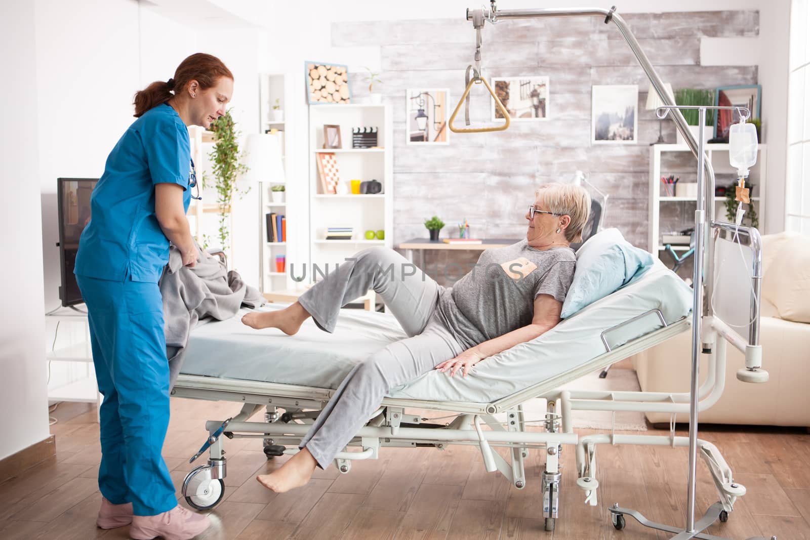 Old woman in nursing home laying on bed by DCStudio