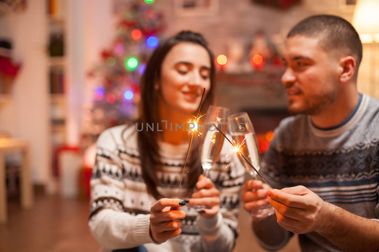 Loving couple holding hand fireworks by DCStudio