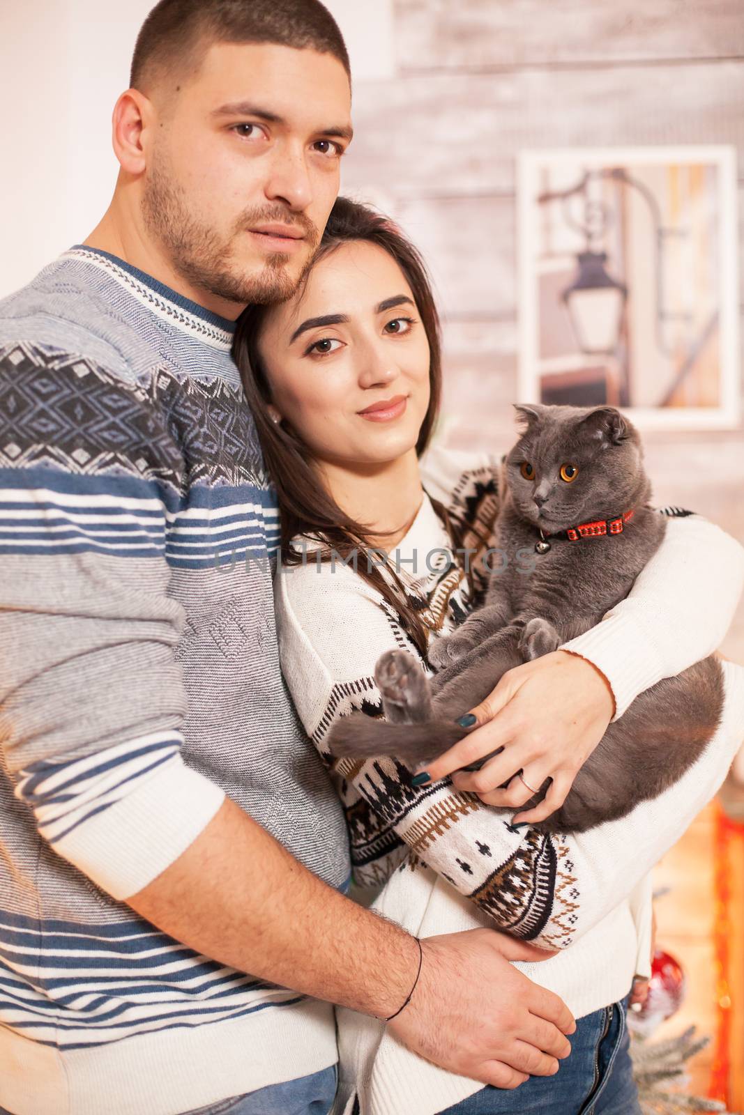 Portrait of happy couple and their cat by DCStudio