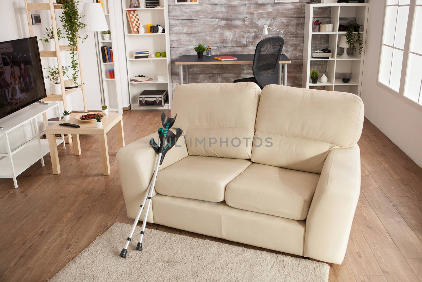 Nursing home interior in bright sunny day with a couch in centre of the room. Modern facility.