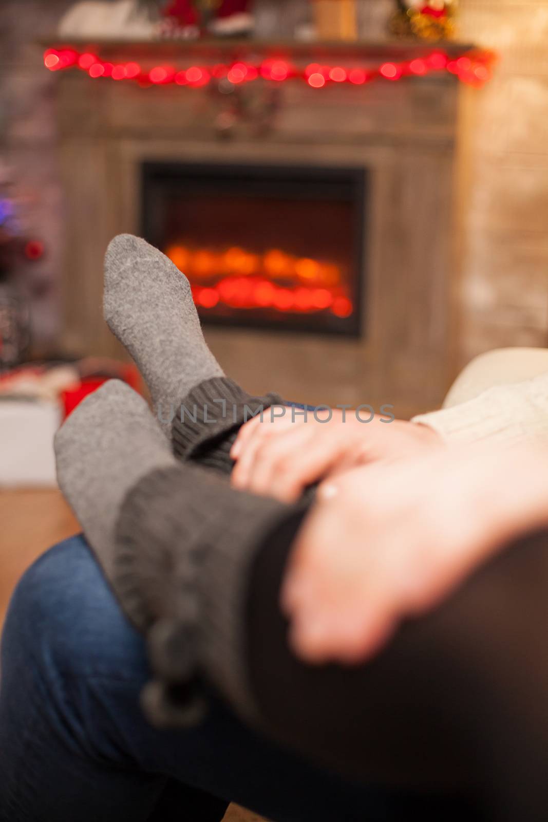 Boyfriend holding his hands on his girlfriend feet by DCStudio