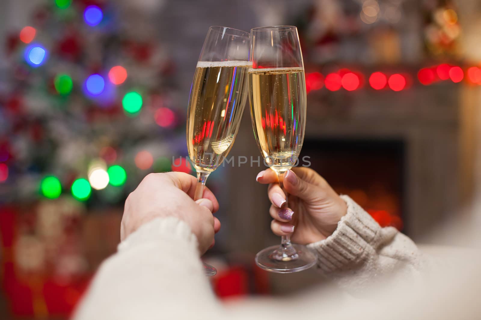 Close up of couple clinking glasses of champagne by DCStudio