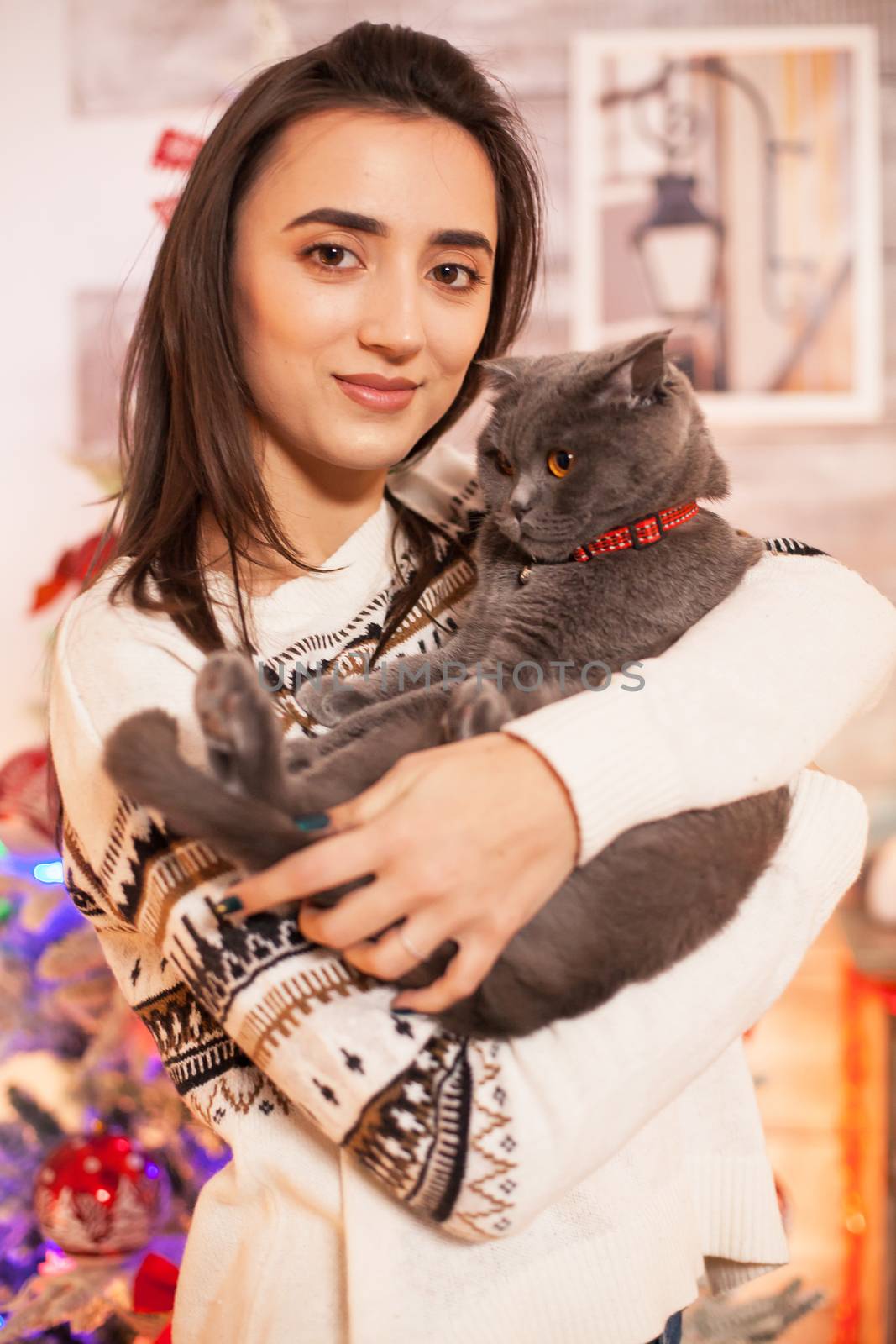 Portrait of happy girl holding her cat by DCStudio