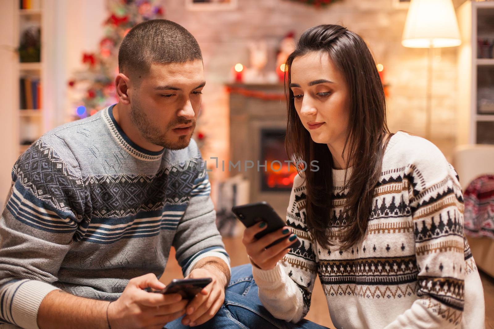 Loving couple browsing on phone by DCStudio