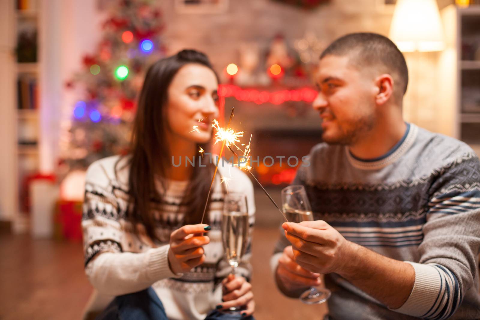 Happy couple holding hand fireworks by DCStudio