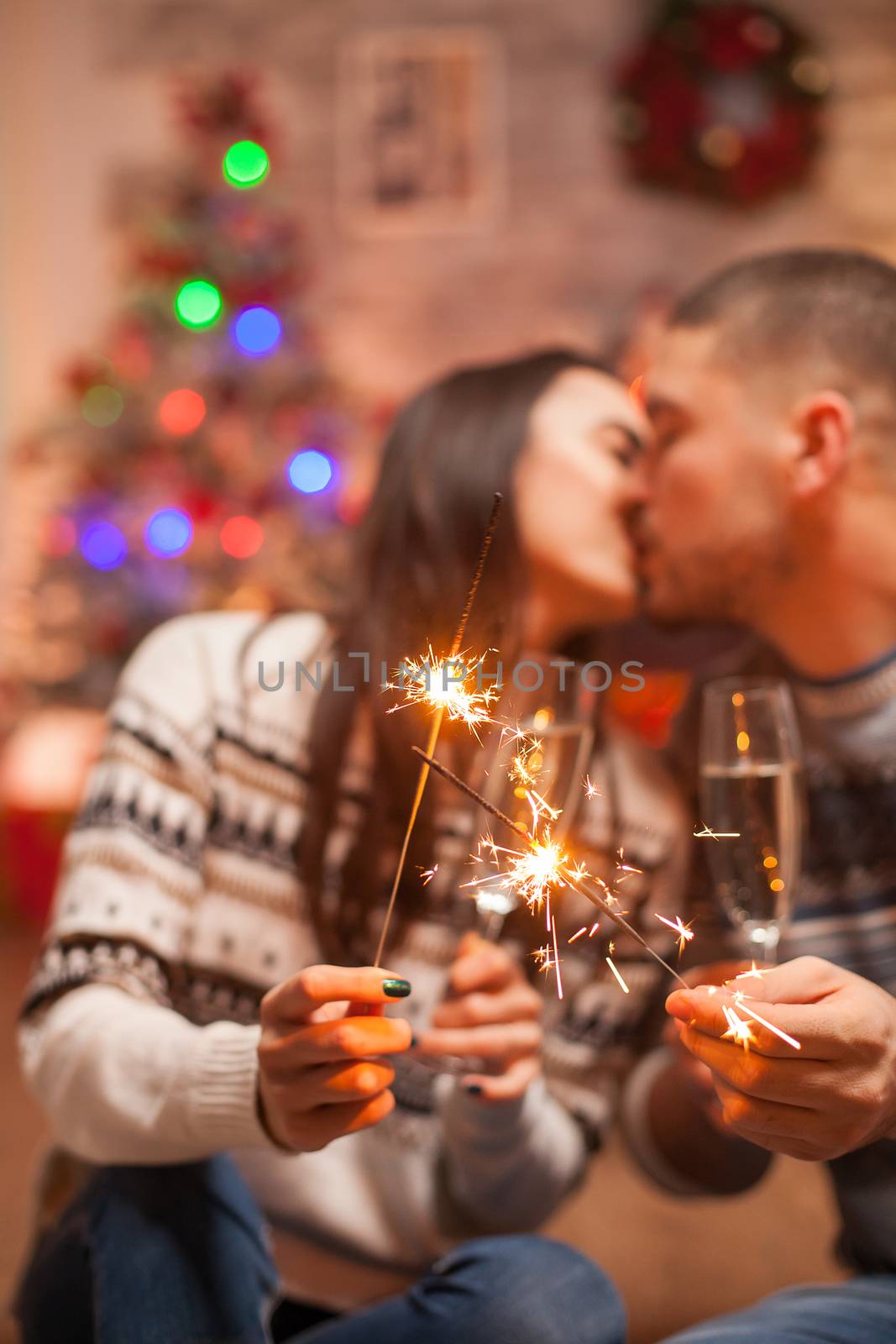 Hand fireworks flicker brightly holded by couple on christmas.