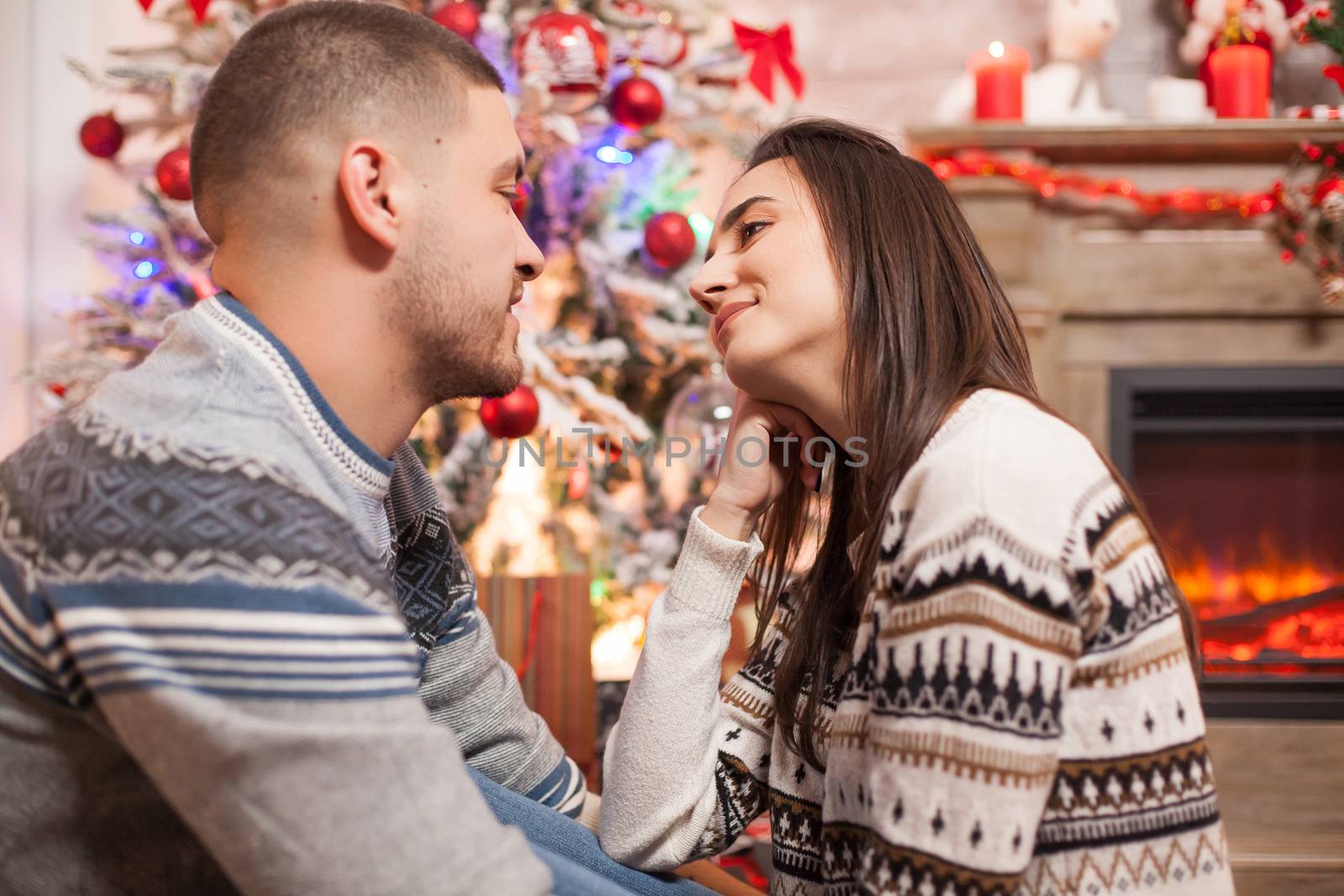 Portrait of happy young couple looking at each other on christmas day.