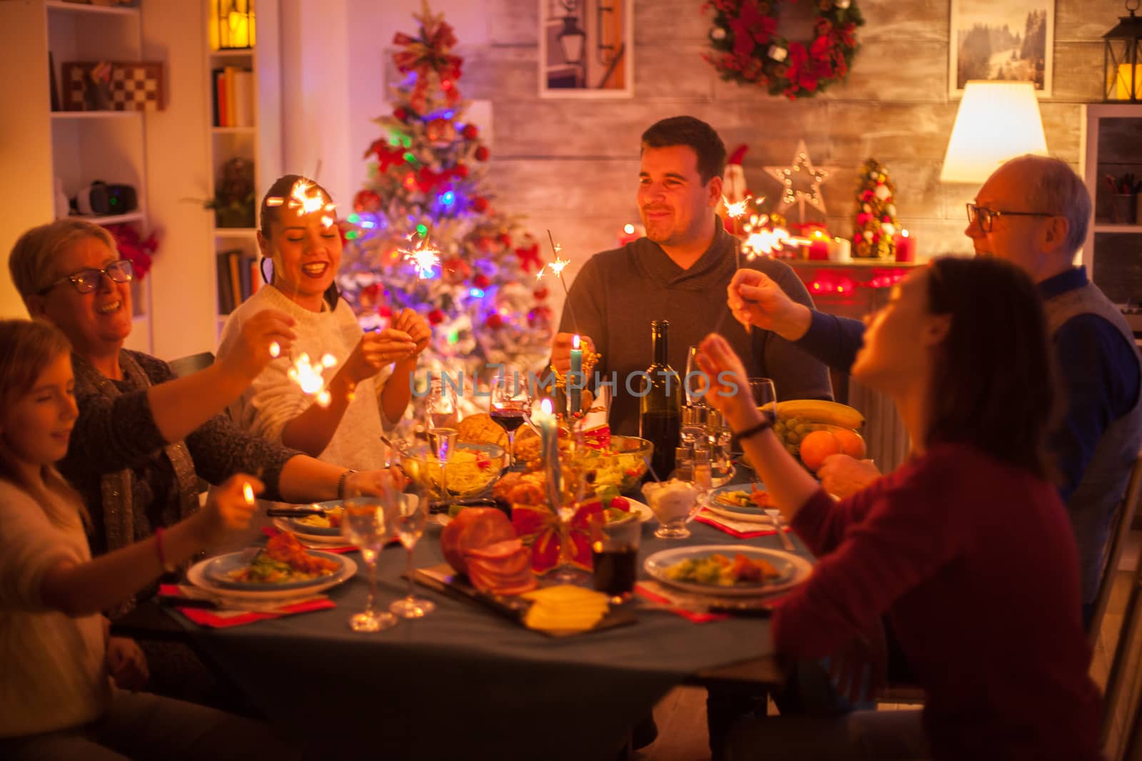 Big happy family celebrating christmas with delicious food and sparkles.