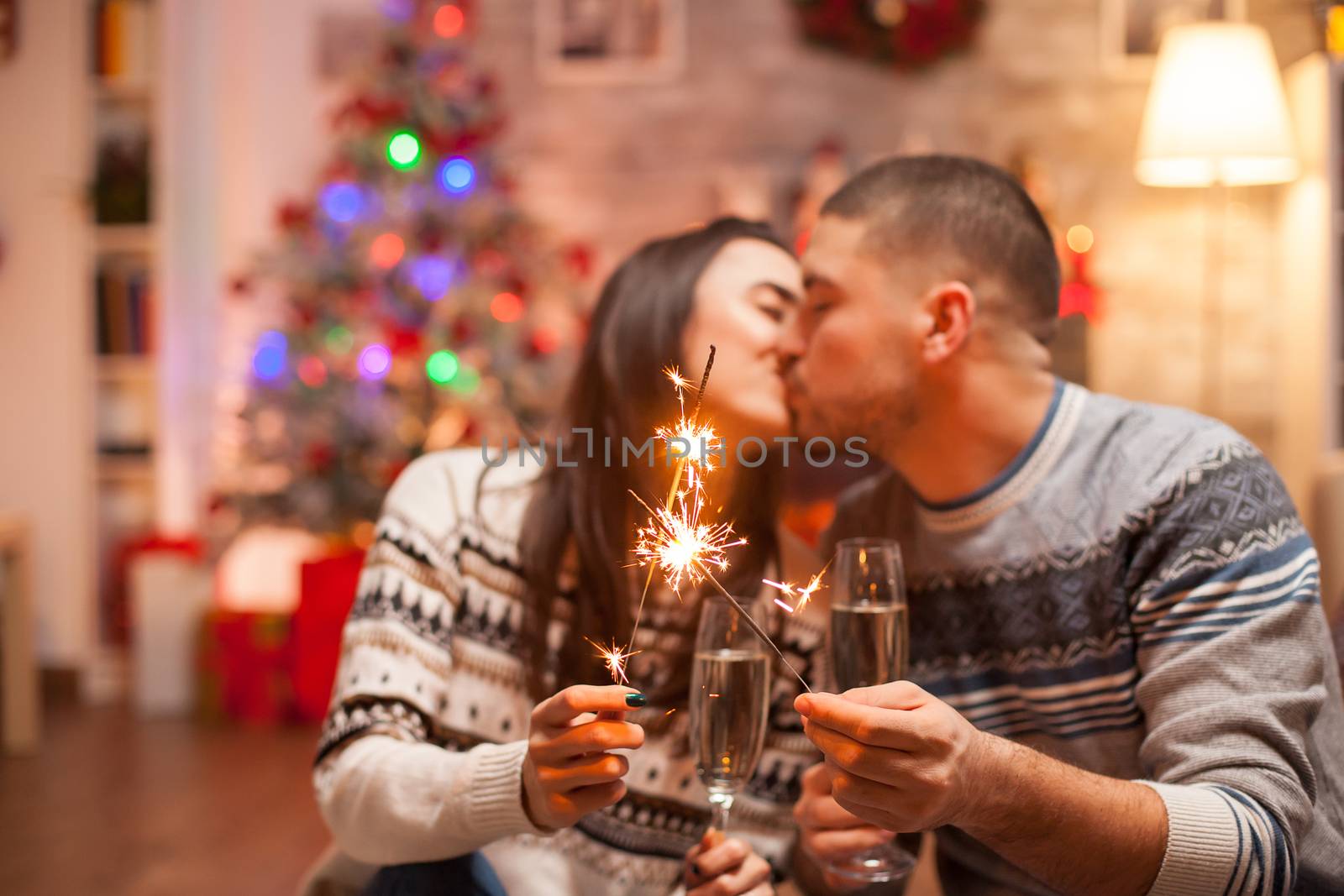 Happy boyfriend kissing girlfriend by DCStudio